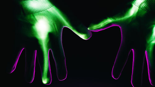 Close-up of hand against black background