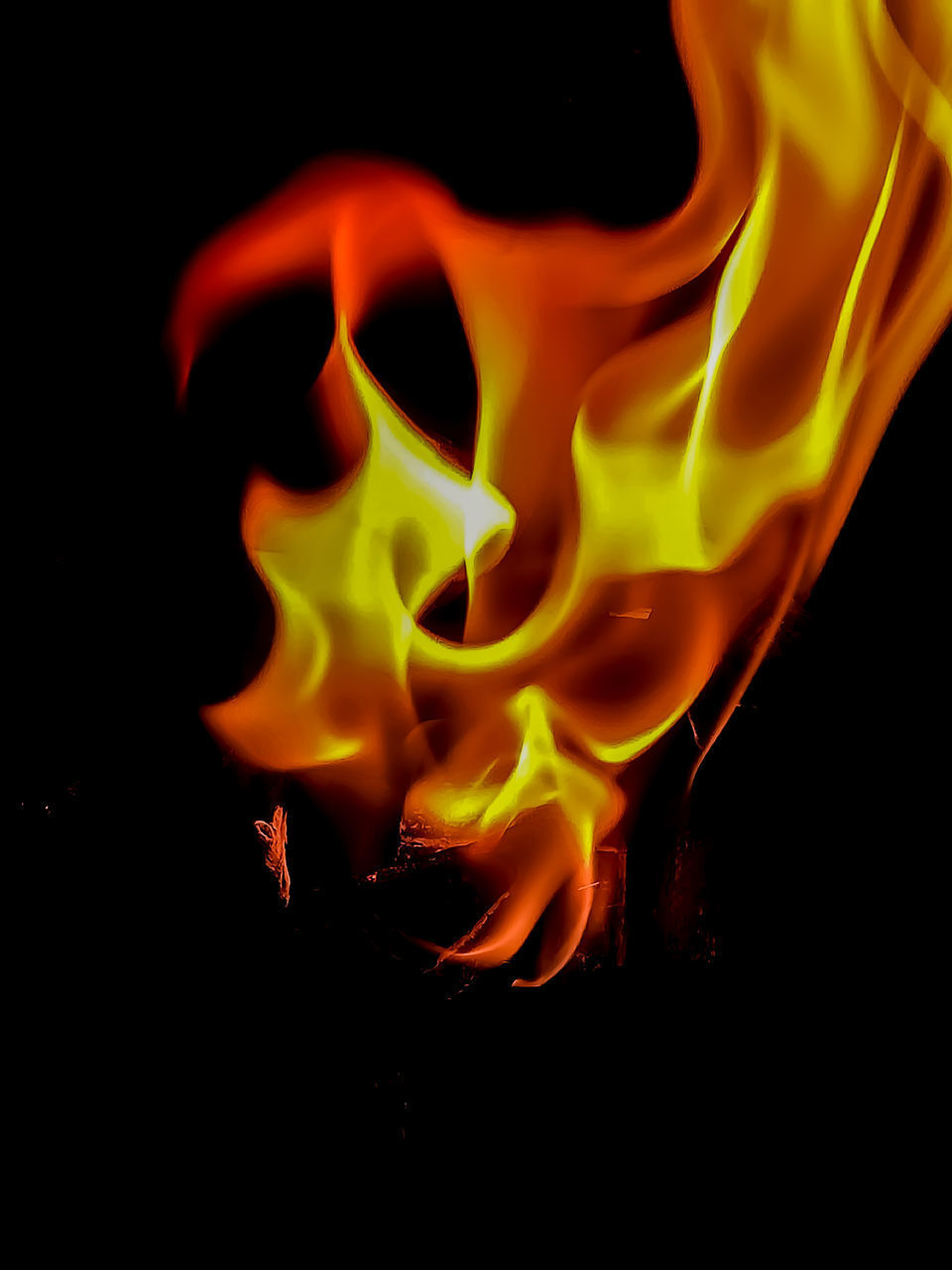 CLOSE-UP OF FIRE BURNING IN THE DARK