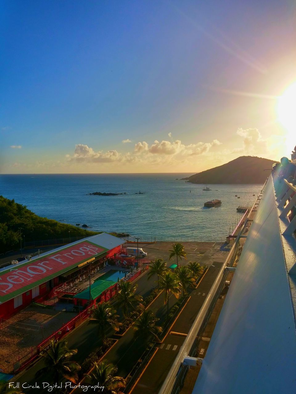 sea, horizon over water, water, sky, beach, sunset, scenics, sun, blue, high angle view, shore, tranquility, beauty in nature, sunlight, tranquil scene, nature, transportation, lens flare, coastline, outdoors