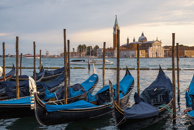 Splendid gondolas moored in venice, in the background the iconic venetian churches