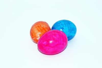 Close-up of multi colored candies against white background