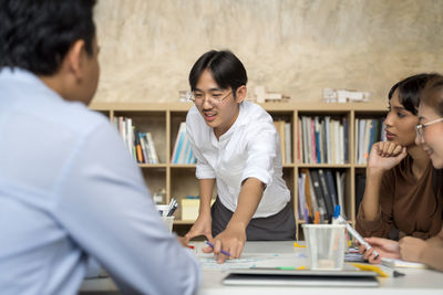 Businessman discussing with colleagues at office