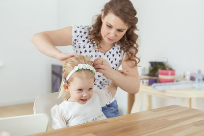 Mother assisting deaf daughter