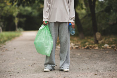 Low section of man standing in park