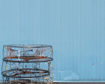 Netted containers next to blue wall