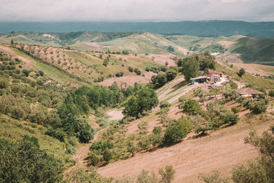 A field in a rural scene surrounded by hills in italy.