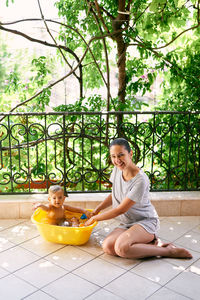 Smiling woman sitting with vegetables