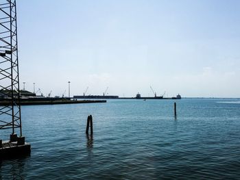 Sailboats in sea against sky