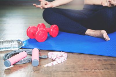 Low section of woman sitting on mat