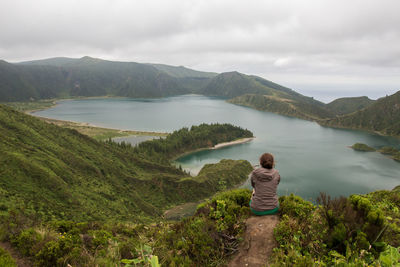 Rear view of woman on lake