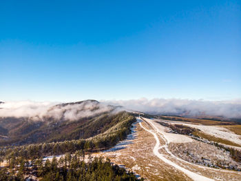 Scenic view of road against clear blue sky