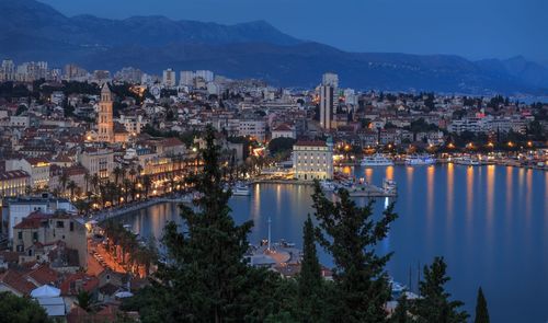 Aerial view of city lit up at night