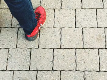 Low section of person standing on footpath