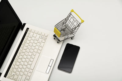 High angle view of laptop on table against white background