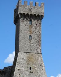 Low angle view of historic building against blue sky