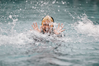 Young woman swimming in lake