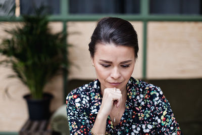 Close-up of serious thoughtful businesswoman at office