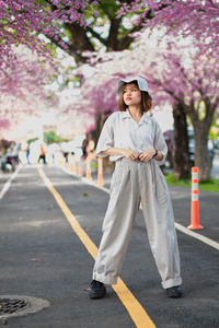 Full length of woman standing on road