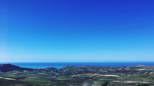 Scenic view of sea against clear blue sky