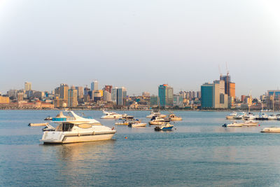 Boats in sea against clear sky