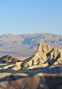 Scenic view of snowcapped mountains against clear blue sky