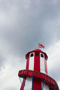 Looking up at a helter skelter with a union jack flag flying at the top