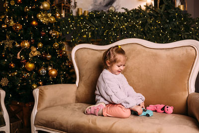 Little child girl having fun and relaxing at home. xmas and new year concept