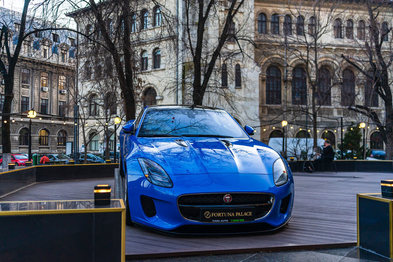 CARS ON STREET BY BUILDINGS IN CITY