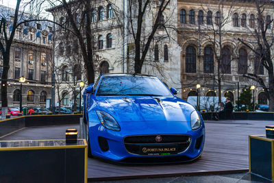 Car on street against buildings in city