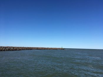 Scenic view of sea against clear blue sky