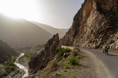 Rear view of people riding on road