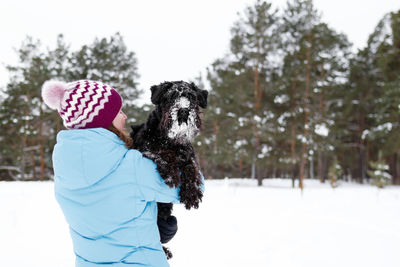 Woman with dog in snow