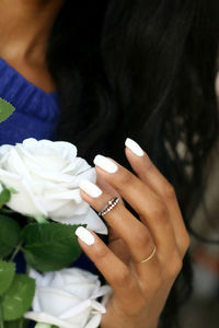 Close-up of hand holding flowers