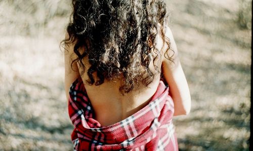 Midsection rear view of woman wrapped in blanket