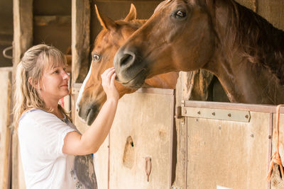 Side view of woman in stable