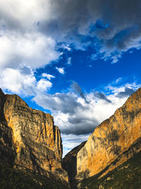 Low angle view of rock formations against sky