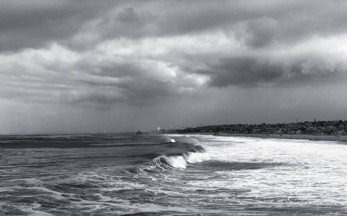 Scenic view of sea against storm clouds