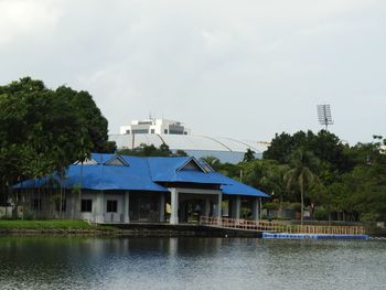Building by lake against sky
