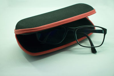 Close-up of sunglasses on table against white background