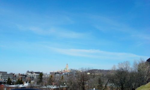 View of cityscape against blue sky