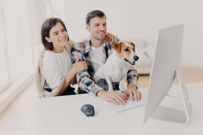 Two dogs sitting on smart phone