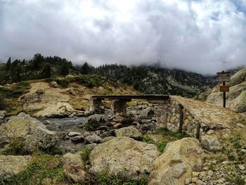 Rocks on landscape against sky