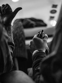 Midsection of man photographing on mobile phone