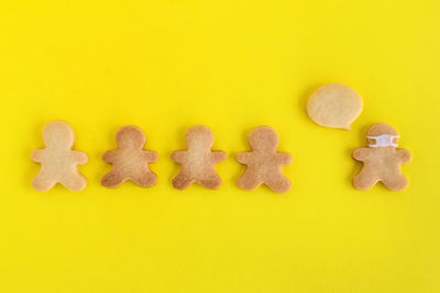 High angle view of cookies against yellow background