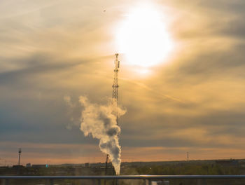 Smoke emitting from chimney against sky during sunset