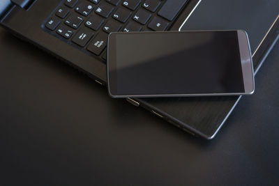 High angle view of laptop and mobile phone on table