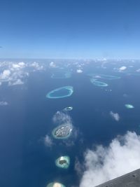 Aerial view of sea against blue sky