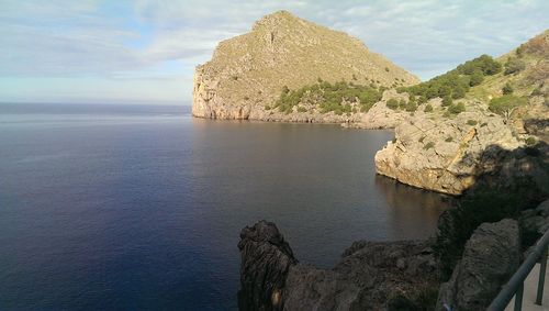 Scenic view of rock formation in sea against sky