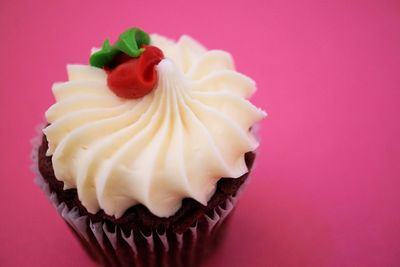 Close-up of cupcakes against pink background