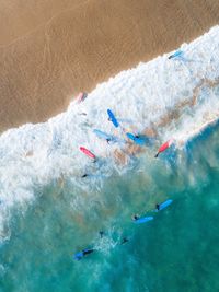 Aerial view of people surfing in sea